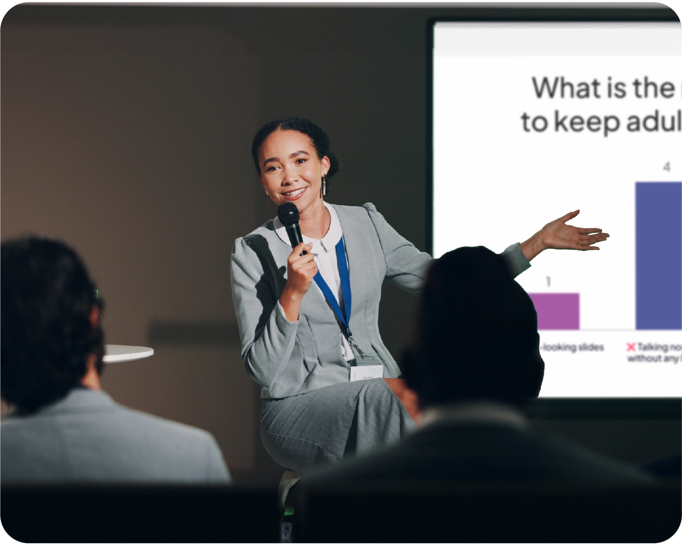 A speaker talking in front of the crowd with AhaSlides showing on the presenter's screen